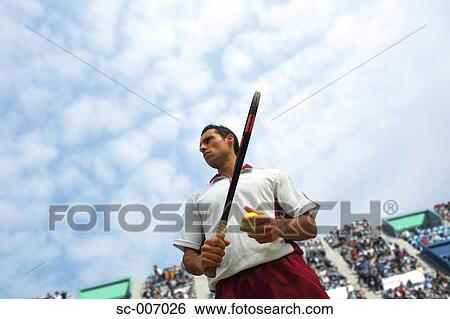 Stock Photograph - Low-Angle View of Male Tennis Player. Fotosearch