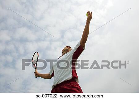 Stock Image - Male Tennis Player Serving. Fotosearch