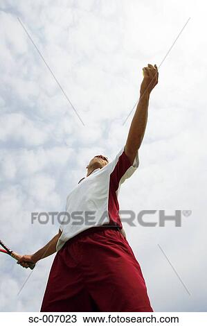 Stock Image - Male Tennis Player Serving. Fotosearch