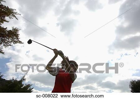 A woman in action of the backswing with a golf club View Large Photo Image Stock Image - A woman in action of the backswing with a golf club. Fotosearch