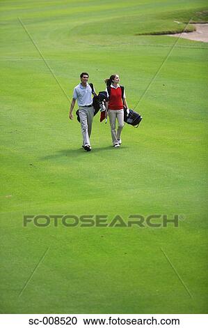 Couple Walks Down the Fairway of a Golf Course View Large Photo Image Stock Image - Couple Walks Down the Fairway of a Golf Course. Fotosearch