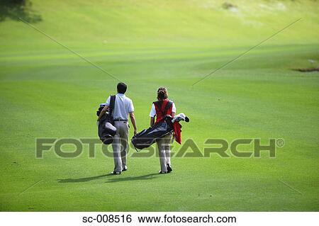 Couple Walks Down the Fairway of a Golf Course View Large Photo Image Stock Photograph - Couple Walks Down the Fairway of a Golf Course. Fotosearch