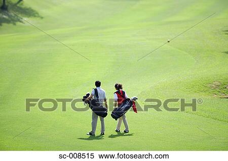 Stock Photography - Couple Walks Down the Fairway of a Golf Course. Fotosearch