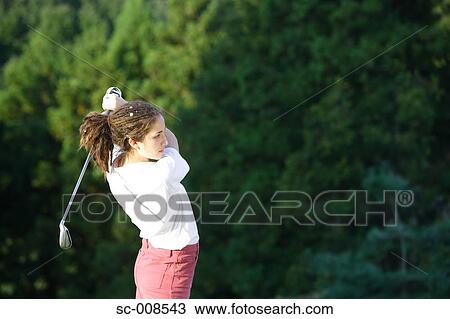 Female Golfer Swinging a Golf Club View Large Photo Image Stock Image - Female Golfer Swinging a Golf Club. Fotosearch