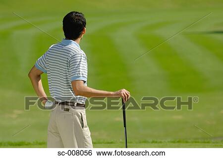 Stock Photograph - Male golfer contemplating his shot. Fotosearch