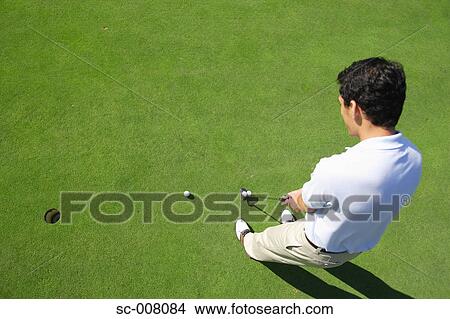 Male golfer making a putt View Large Photo Image Picture - Male golfer making a putt. Fotosearch