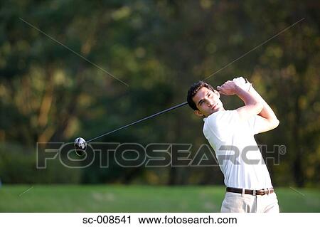 Stock Image - Male Golfer Swinging a Golf Club. Fotosearch