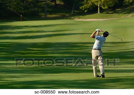Male Golfer Swinging a Golf Club View Large Photo Image Stock Image - Male Golfer Swinging a Golf Club. Fotosearch