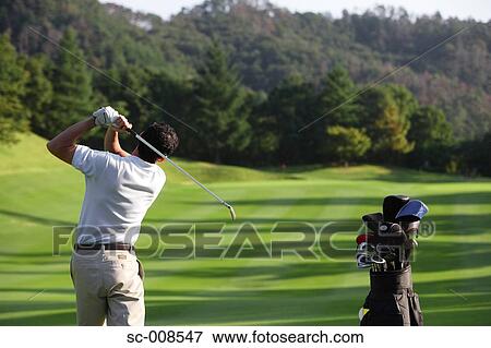Stock Photo - Male Golfer Swinging a Golf Club. Fotosearch