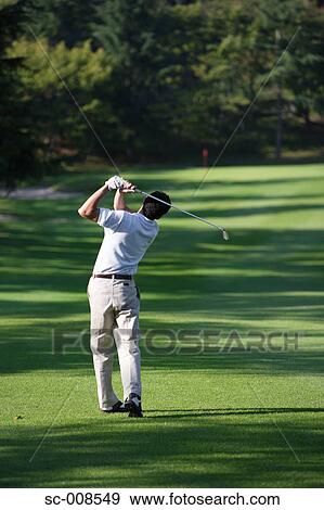 Stock Photo - Male Golfer Swinging a Golf Club. Fotosearch