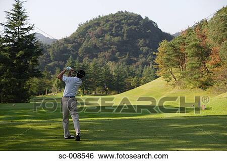 Male Golfer Swinging a Golf Club View Large Photo Image Stock Photograph - Male Golfer Swinging a Golf Club. Fotosearch