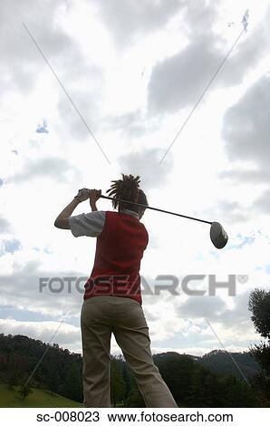 Rear view of a woman in action playing golf in the golf course View Large Photo Image Stock Image - Rear view of a woman in action playing golf in the golf course. Fotosearch