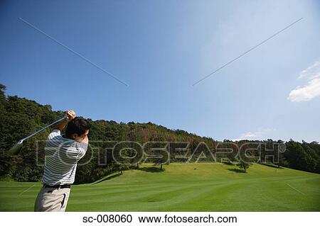 Side view of male golfer in action View Large Photo Image Stock Image - Side view of male golfer in action. Fotosearch