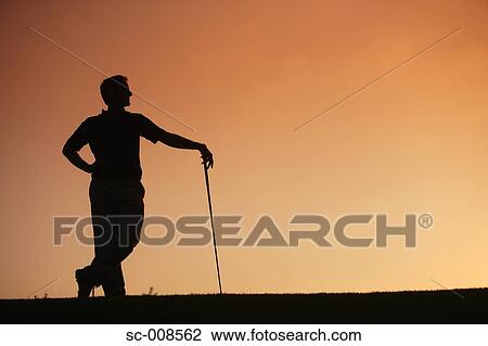 Stock Image - Silhouette of a Male Golfer Standing. Fotosearch