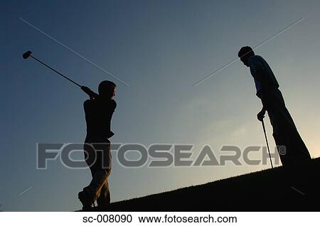 Silhouette of a man in action hitting a golf shot View Large Photo Image Stock Image - Silhouette of a man in action hitting a golf shot. Fotosearch