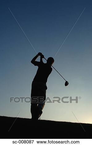 Silhouette of a man in action hitting a golf shot View Large Photo Image Stock Photo - Silhouette of a man in action hitting a golf shot. Fotosearch