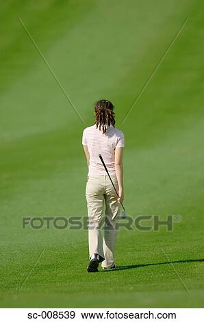Young Female Golfer Walking Down a Fairway View Large Photo Image Stock Photo - Young Female Golfer Walking Down a Fairway. Fotosearch