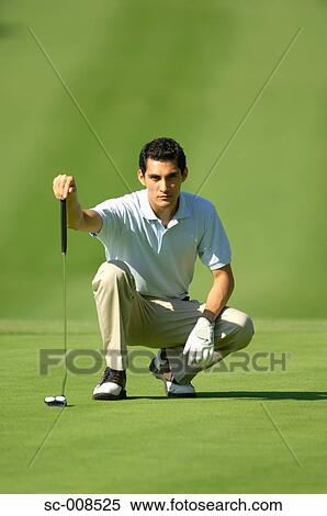 Stock Photography - Young Man Plans a Golf Shot. Fotosearch