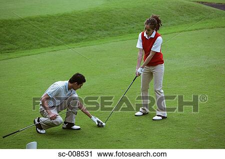 Young Man Teaches a Young Woman How to Play Golf View Large Photo Image Stock Image - Young Man Teaches a Young Woman How to Play Golf. Fotosearch