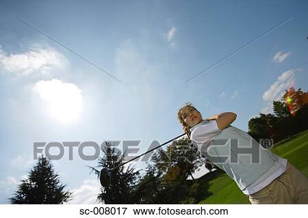 Young woman making a stroke with a driver View Large Photo Image Stock Photo - Young woman making a stroke with a driver. Fotosearch