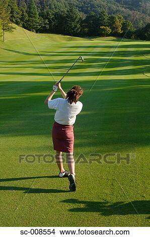 Picture - Young Woman Playing Golf. Fotosearch