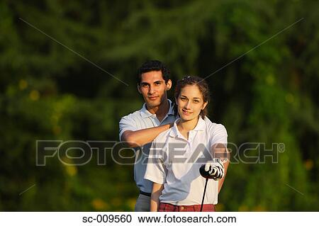 Stock Image - A happy couple smiles in front of the camera. Fotosearch