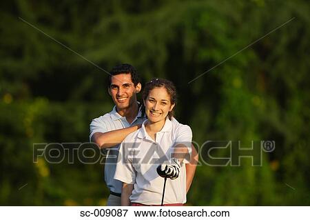 A happy couple smiling in front of the camera View Large Photo Image Stock Photo - A happy couple smiling in front of the camera. Fotosearch