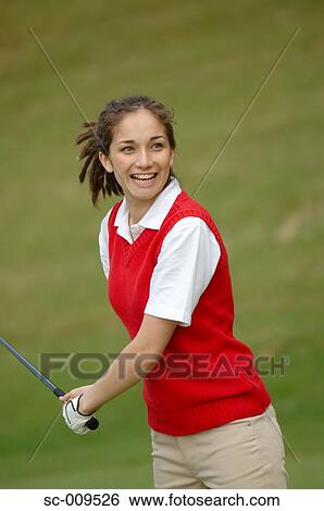 Stock Photograph - A woman smiles after making a good shot. Fotosearch