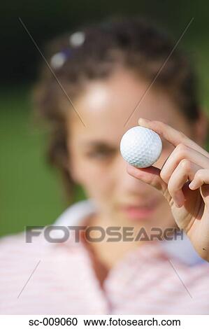 Close up of a golf ball held by a woman View Large Photo Image Stock Image - Close up of a golf ball held by a woman. Fotosearch