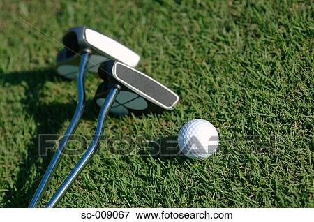 Close up of a golf ball with two putters View Large Photo Image Stock Photo - Close up of a golf ball with two putters. Fotosearch