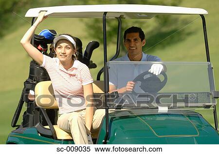 Stock Photography - Couple resting in a golf cart. Fotosearch
