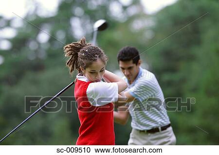 Stock Image - Female Golfer and a Male Golfer . Fotosearch