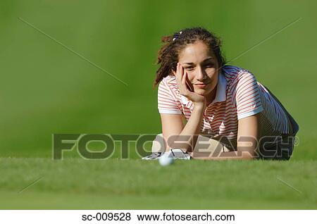 Female golfer lying on the grass View Large Photo Image Stock Photo - Female golfer lying on the grass. Fotosearch