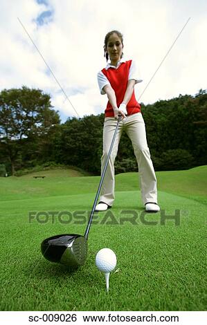 Female golfer preparing to hit her tee shot View Large Photo Image Stock Photograph - Female golfer preparing to hit her tee shot. Fotosearch