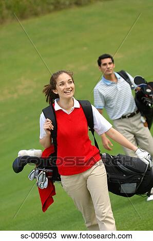 Female golfer walking down the fairway View Large Photo Image Stock Image - Female golfer walking down the fairway. Fotosearch