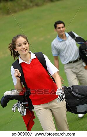 Female golfer walking down the fairway View Large Photo Image Stock Photo - Female golfer walking down the fairway. Fotosearch