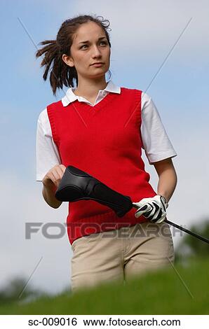 Portrait of a female golfer holding a golf club View Large Photo Image Stock Photograph - Portrait of a female golfer holding a golf club. Fotosearch