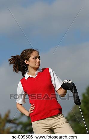 Portrait of a female golfer holding a golf club View Large Photo Image Stock Photograph - Portrait of a female golfer holding a golf club. Fotosearch