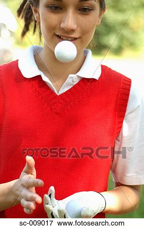 Portrait of a female player playing with a golf ball View Large Photo Image Stock Photo - Portrait of a female player playing with a golf ball. Fotosearch