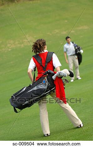 Picture - Rear view of a woman with golf bag. Fotosearch