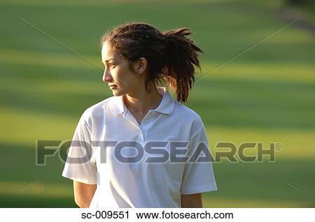 Stock Image - Side view of a woman in contemplation. Fotosearch