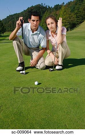 Smiling couple on a green View Large Photo Image Picture - Smiling couple on a green. Fotosearch