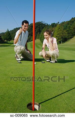 Stock Photography - Smiling couple on a green. Fotosearch