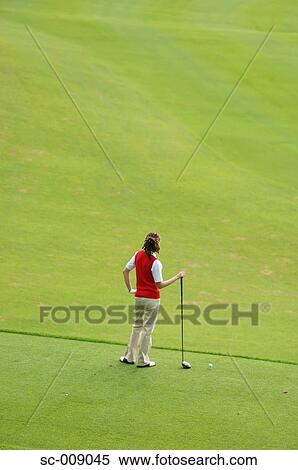 Stock Photography - Wide Shot of Female Golfer on Golf Course. Fotosearch