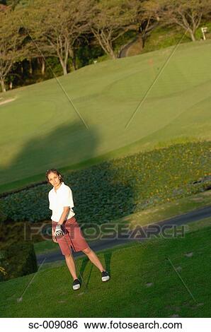 Stock Photograph - Woman posing on the tee ground. Fotosearch
