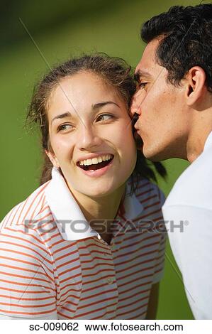 Young Female Golfer Being Kissed on the Cheek by Young Man View Large Photo Image Stock Image - Young Female Golfer Being Kissed on the Cheek by Young Man. Fotosearch