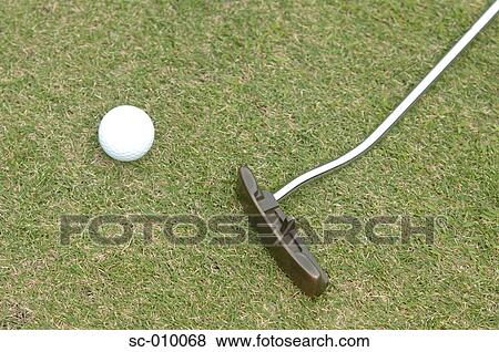 Stock Photo - Close up of a putter and a golf ball. Fotosearch