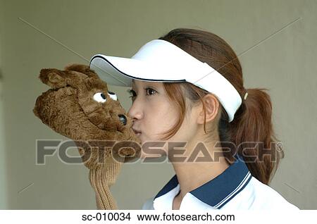 Close up of the woman kissing the head cover of a golf club View Large Photo Image Picture - Close up of the woman kissing the head cover of a golf club. Fotosearch