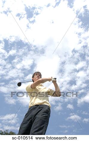 High angle view of a man playing a golf stroke View Large Photo Image Picture - High angle view of a man playing a golf stroke. Fotosearch