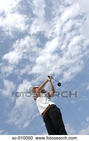 High angle view of a man playing a golf stroke View Large Photo Image Stock Image - High angle view of a man playing a golf stroke. Fotosearch